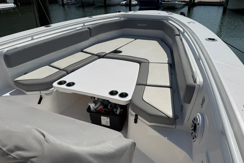 Slide: The Image of 2022 Everglades 365 Center Console boat with spacious seating and table setup. - 25