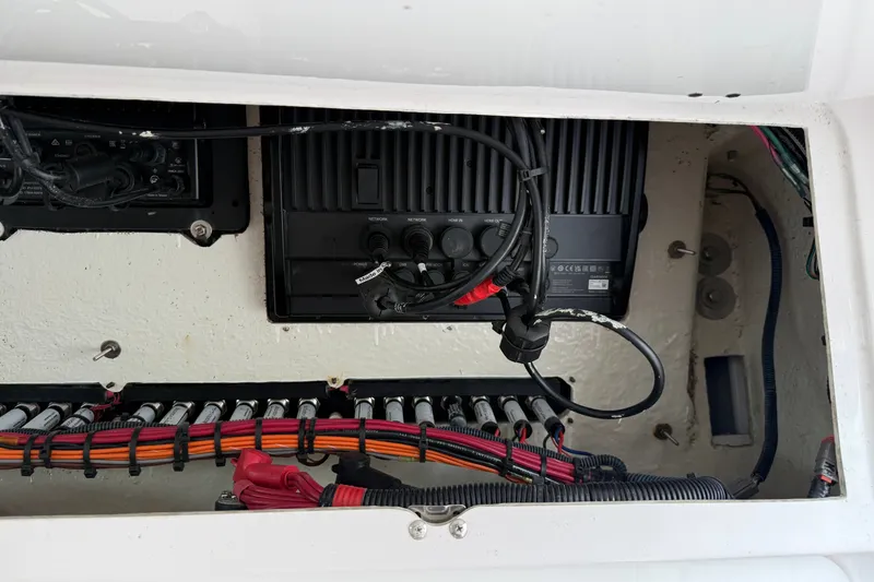 Slide: The Image of Electrical wiring and components inside a 2022 Everglades 365 Center Console boat. - 54