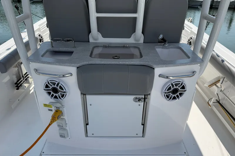 Slide: The Image of 2022 Everglades 365 Center Console boat interior with sink, speakers, and storage. - 45