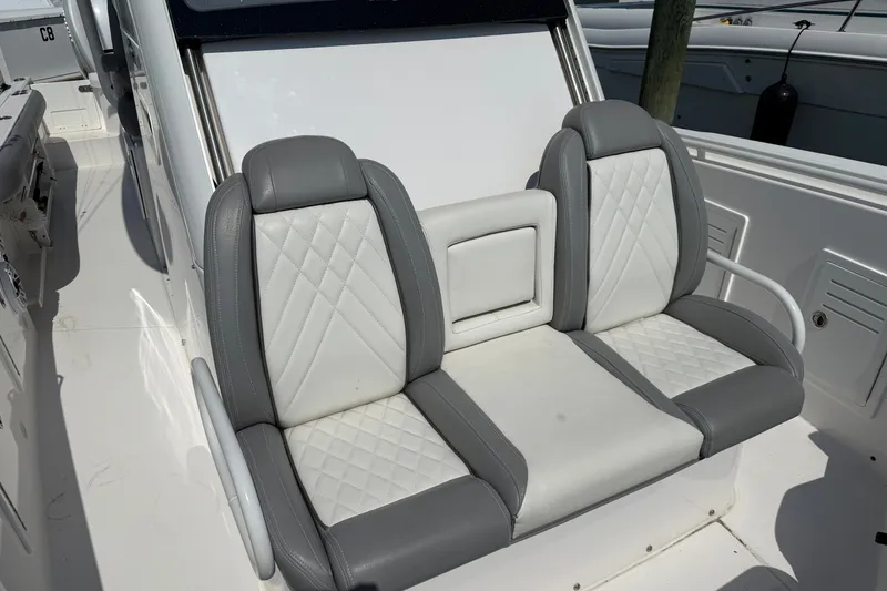 Slide: The Image of 2022 Everglades 365 Center Console boat with dual gray and white cushioned seats. - 46