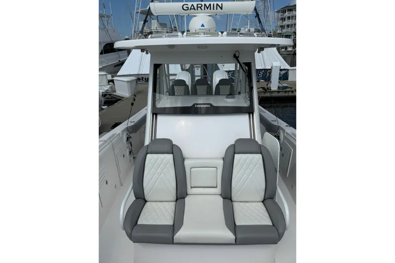 Slide: The Image of 2022 Everglades 365 Center Console boat with cushioned seating and Garmin equipment. - 26