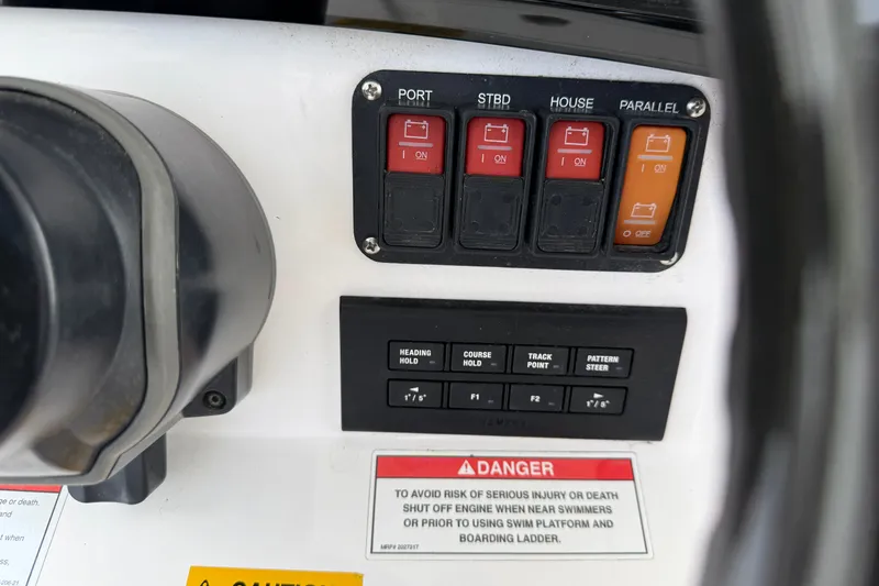 Slide: The Image of Control panel of 2022 Everglades 365 Center Console boat with switches and warning label. - 13