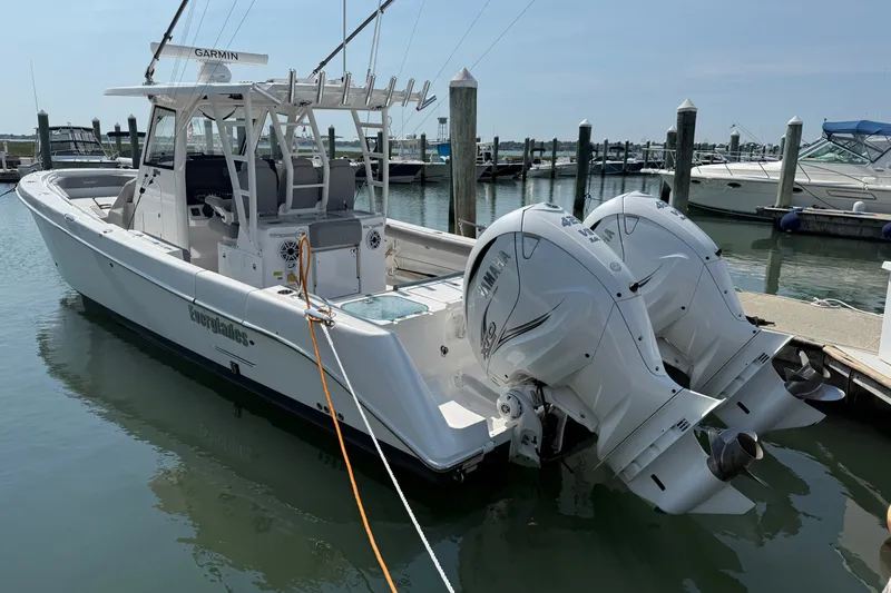 Slide: The Image of 2022 Everglades 365 Center Console boat docked with twin Yamaha outboard engines. - 42