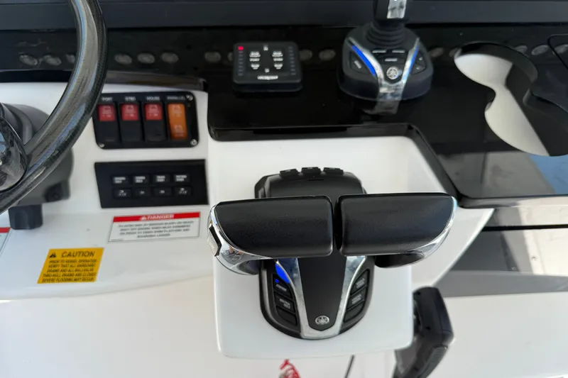 Slide: The Image of Control panel of 2022 Everglades 365 Center Console boat with throttle and switches. - 52