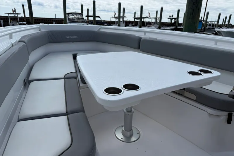 Slide: The Image of 2022 Everglades 365 Center Console boat with spacious seating and table with cup holders. - 24