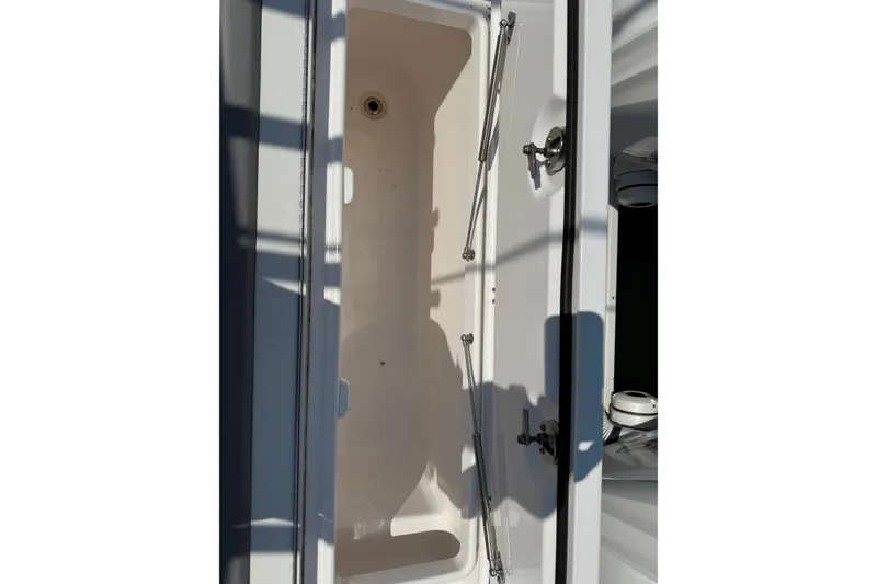 Slide: The Image of Open storage compartment on 2022 Everglades 365 Center Console boat. - 49