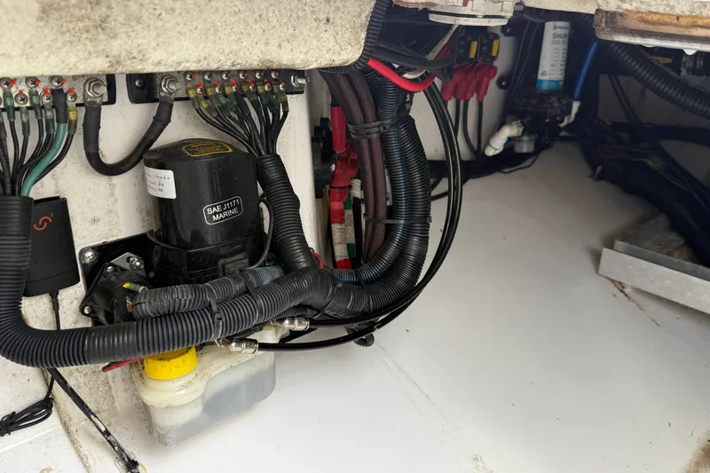Slide: The Image of Electrical wiring and components inside a 2022 Everglades 365 Center Console boat. - 51