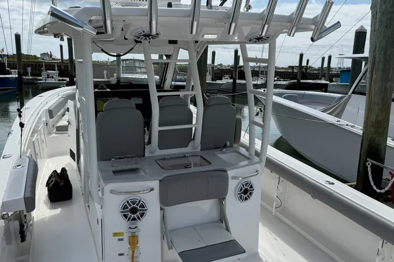 Slide: The Image of 2022 Everglades 365 Center Console boat docked, featuring sleek design and modern amenities. - 35