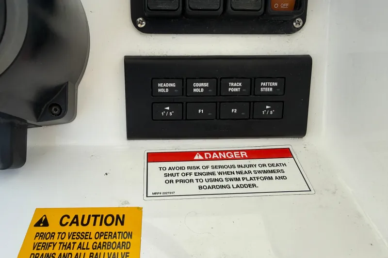Slide: The Image of Control panel of 2022 Everglades 365 Center Console with safety warnings and navigation buttons. - 14