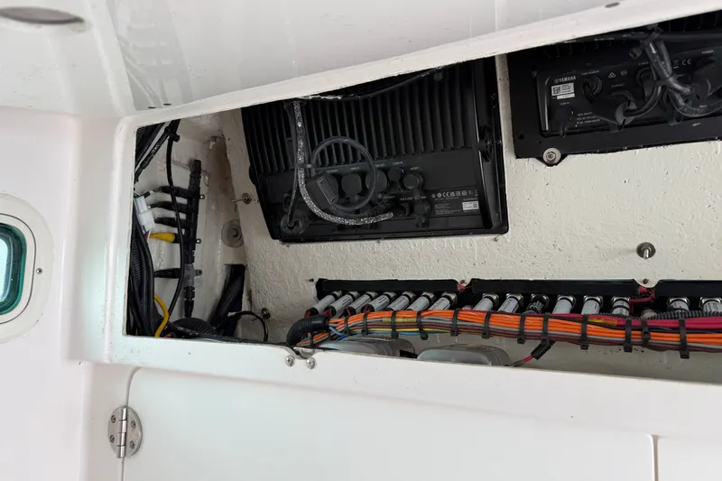 Slide: The Image of Electrical wiring and components inside a 2022 Everglades 365 Center Console boat. - 53