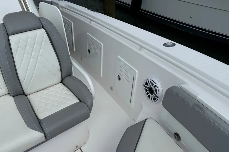 Slide: The Image of Luxury seating on 2022 Everglades 365 Center Console boat with speaker and storage compartments. - 28