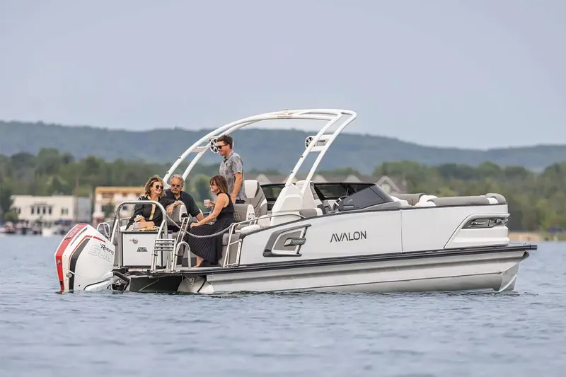 Slide: The Image of Manufacturer Provided Image: 2025 Avalon Excalibur LTD Quad Lounge boat on a lake with passengers enjoying the ride. - 4