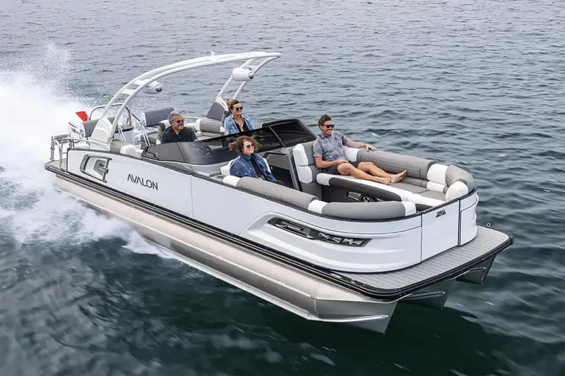 Slide: The Image of Manufacturer Provided Image: 2025 Avalon Excalibur LTD Quad Lounge Windshield pontoon boat cruising on open water. - 2
