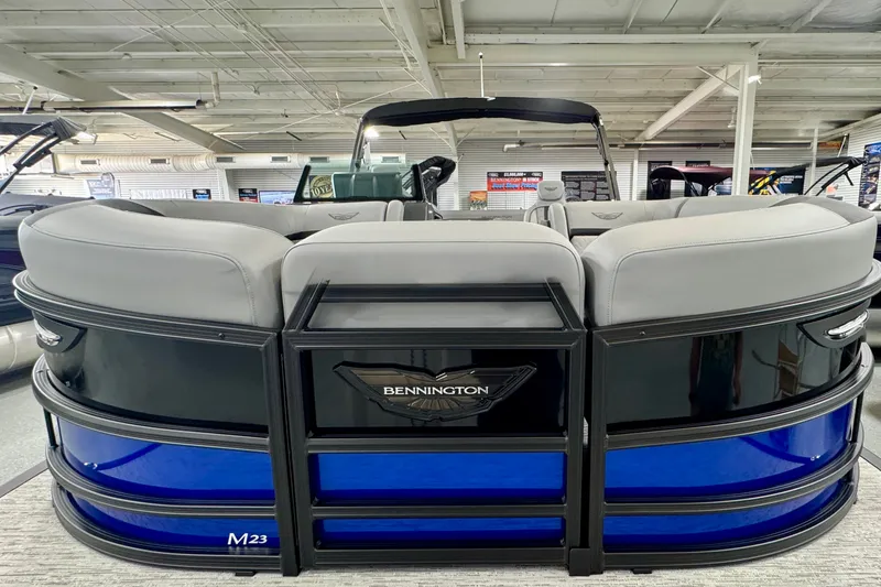 Slide: The Image of 2026 Bennington 23 M Center Swingback pontoon boat with sleek design in showroom. - 23