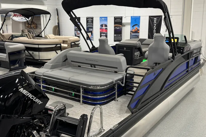 Slide: The Image of 2026 Bennington 23 M Center Swingback pontoon boat with Mercury engine in showroom. - 28