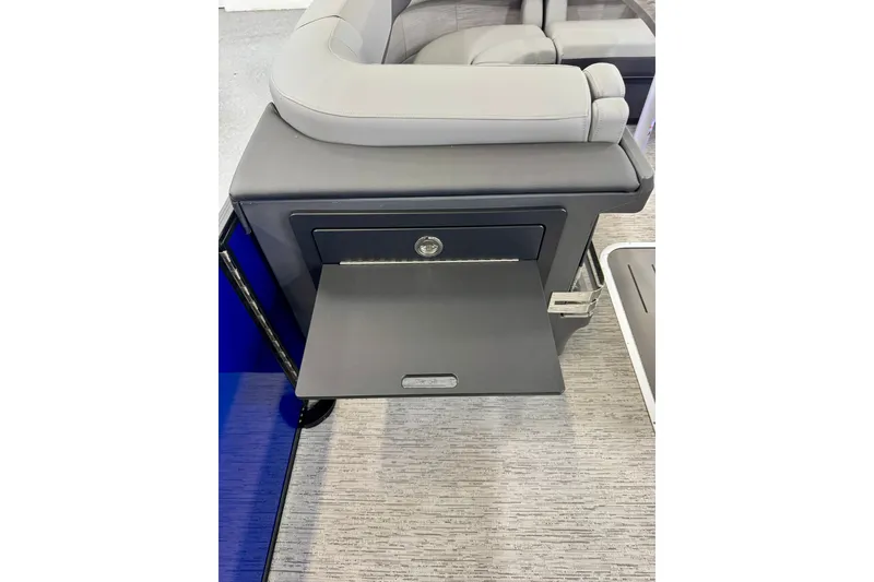 Slide: The Image of 2026 Bennington 23 M Center Swingback interior with sleek seating and storage compartment. - 14