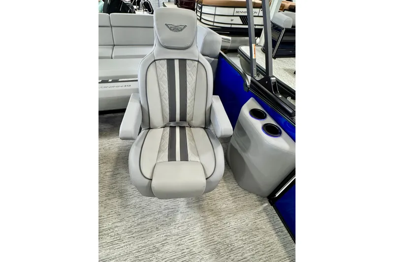 Slide: The Image of Luxurious seating on 2026 Bennington 23 M Center Swingback boat, featuring sleek design and cup holders. - 13