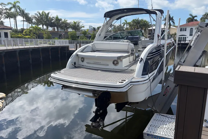 Slide: The Image of 2017 Formula 290 Bowrider docked, showcasing sleek design and spacious seating. - 3