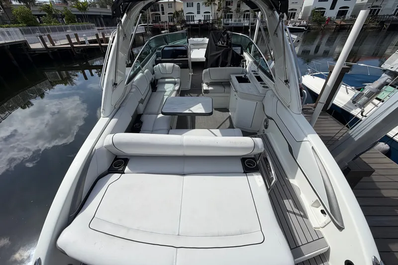 Slide: The Image of 2017 Formula 290 Bowrider with spacious seating and sleek design docked by the water. - 8