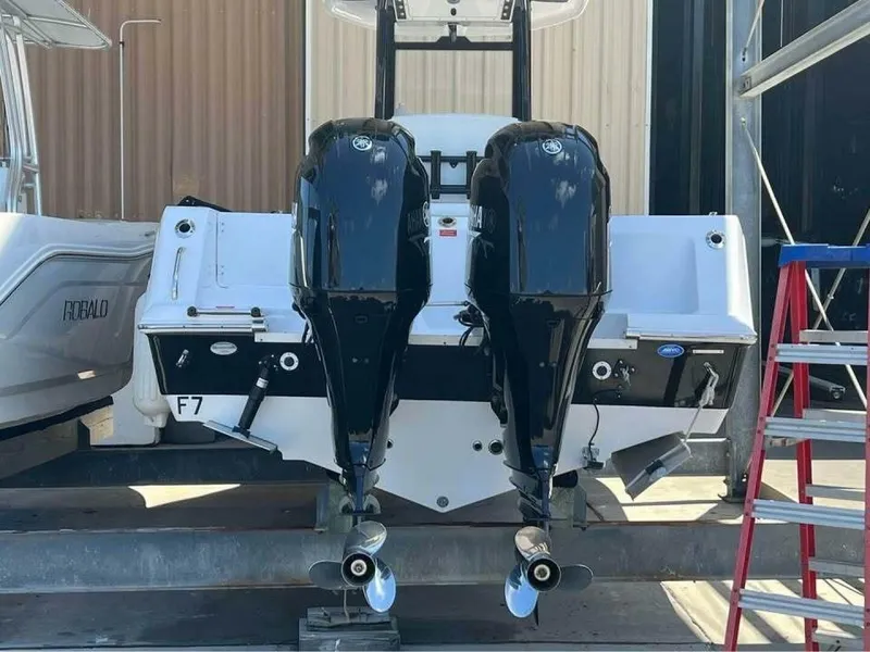 Slide: The Image of The image shows the rear of a Tidewater 256 CC Adventure boat with two outboard engines. - 13