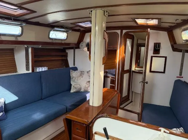 Slide: The Image of The interior of a 1989 Morgan 440 features a cozy seating area with blue upholstery. - 46