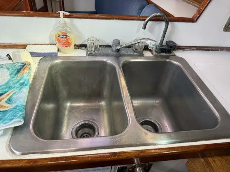 Slide: The Image of Stainless steel double sink in a boat galley with faucet and soap dispenser. - 49
