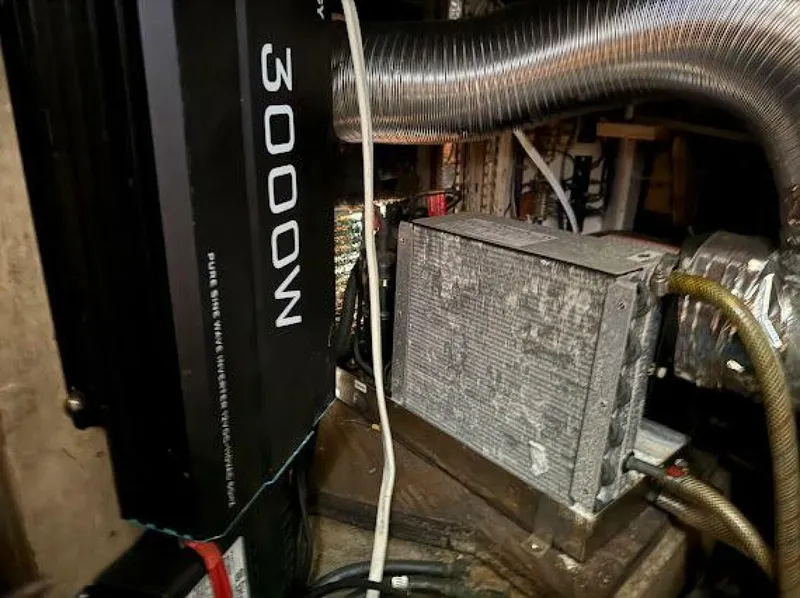 Slide: The Image of An engine room with a 3000-watt inverter and various hoses and cables. - 15