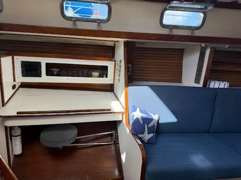 Slide: The Image of Interior of a 1989 Morgan 440 with a blue couch and wooden accents. - 44