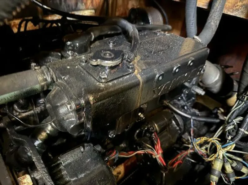 Slide: The Image of Close-up of an engine compartment with an old, oily engine and wires. - 20