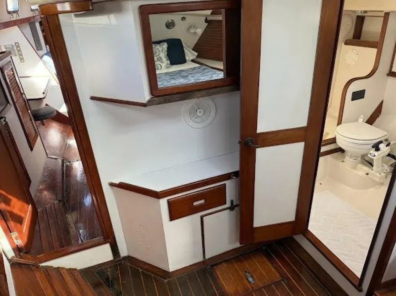 Slide: The Image of Interior of a sailboat with wooden floors, a cabinet, and a toilet. - 24