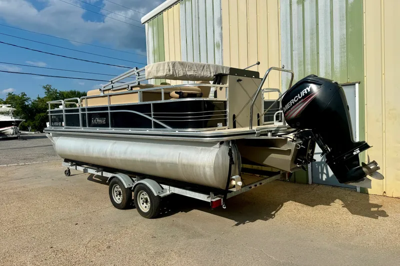 Slide: The Image of 2017 Lowe SF 214 Sport Fish pontoon boat on trailer with Mercury outboard motor. - 1