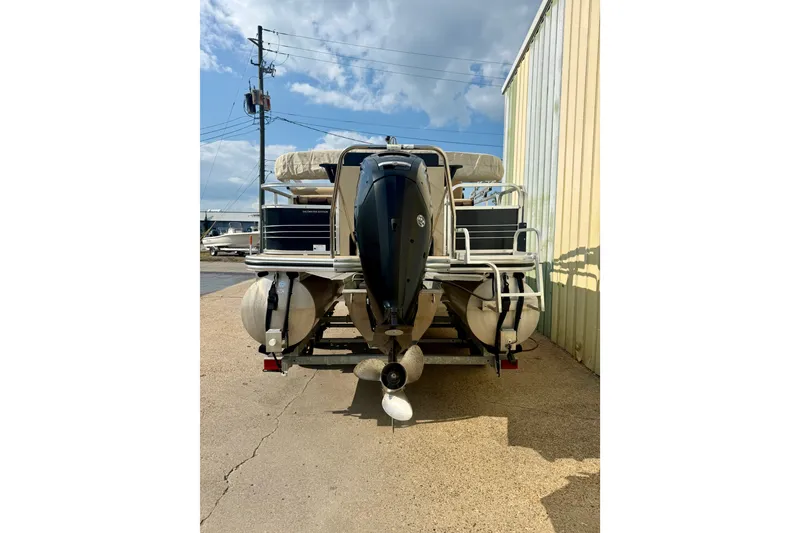 Slide: The Image of 2017 Lowe SF 214 Sport Fish pontoon boat with outboard motor, parked outdoors. - 2