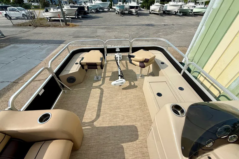 Slide: The Image of 2017 Lowe SF 214 Sport Fish boat interior with beige seating and fishing equipment. - 8