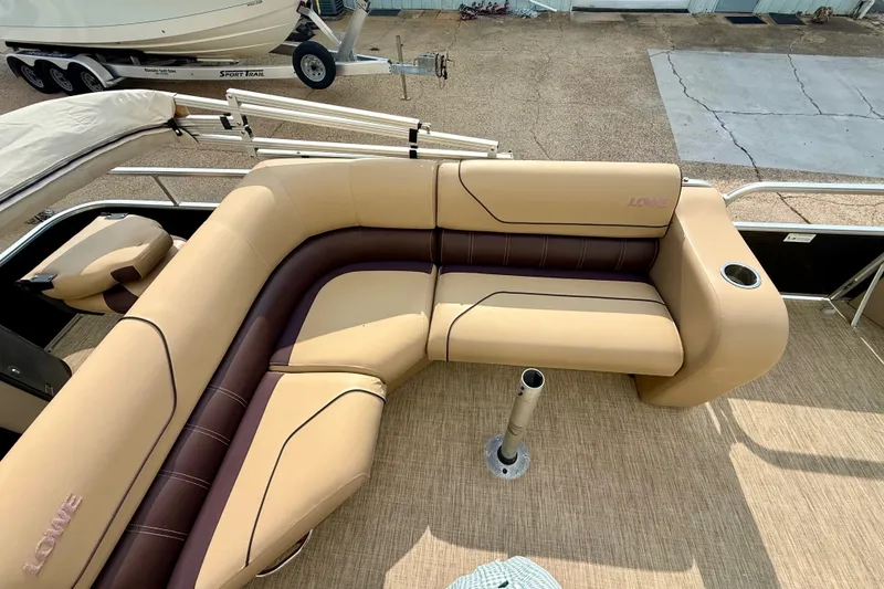 Slide: The Image of Luxurious seating on 2017 Lowe SF 214 Sport Fish boat, featuring tan and brown upholstery. - 9