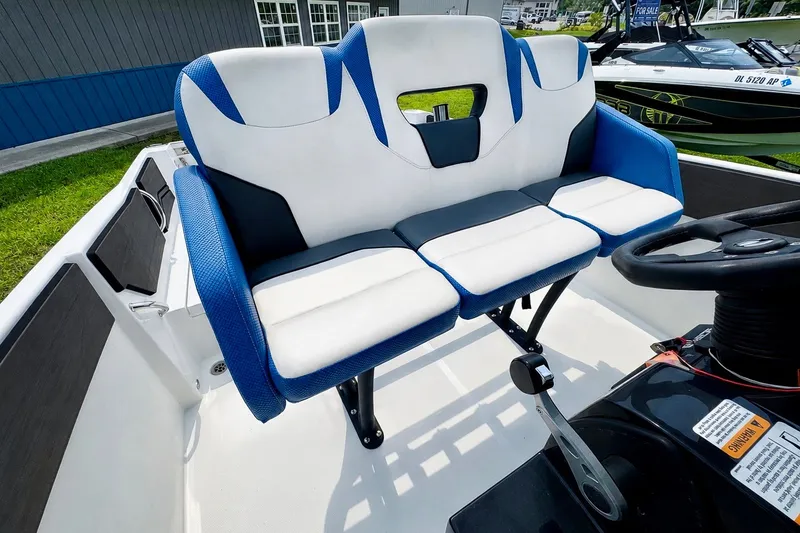 Slide: The Image of 2022 Scarab 255 Open ID boat interior with blue and white seating and steering wheel. - 15