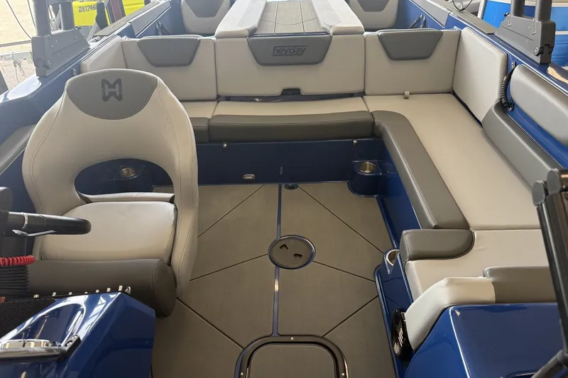 Slide: The Image of Interior of 2026 Heyday WT-2DC boat with gray seating and blue accents. - 8