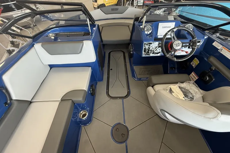 Slide: The Image of Interior of 2026 Heyday WT-2DC boat with modern seating and steering console. - 11
