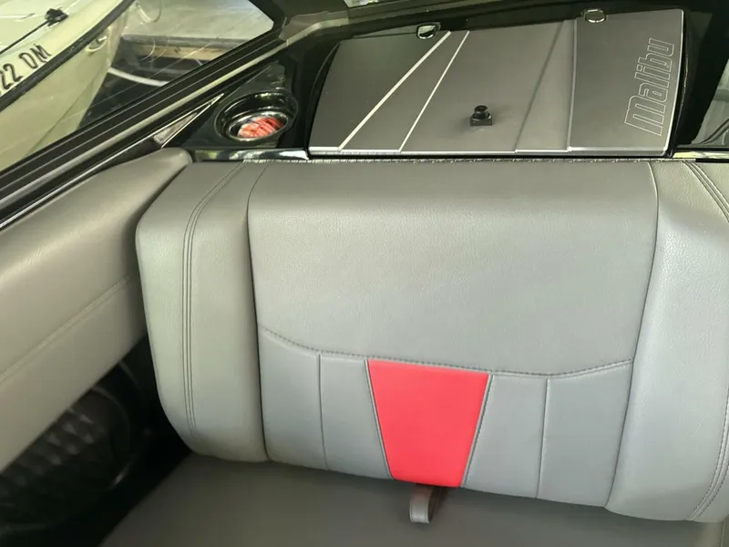 Slide: The Image of The image shows the gray and red upholstery of a 2022 Malibu Wakesetter 23 LSV. - 36