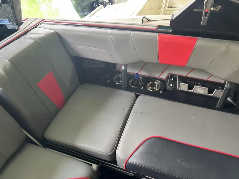 Slide: The Image of The interior of a 2022 Malibu Wakesetter 23 LSV with gray and red upholstery. - 49
