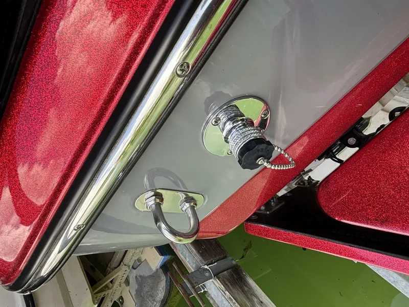 Slide: The Image of Close-up of a 2022 Malibu Wakesetter 23 LSV with a shiny red hull and metal fittings. - 46