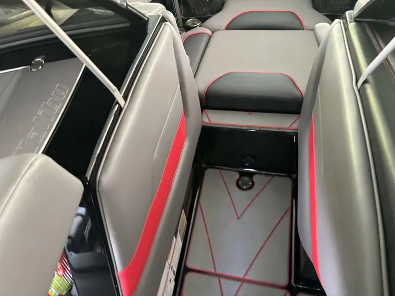 Slide: The Image of The image shows the interior of a 2022 Malibu Wakesetter 23 LSV with gray and red seating. - 24