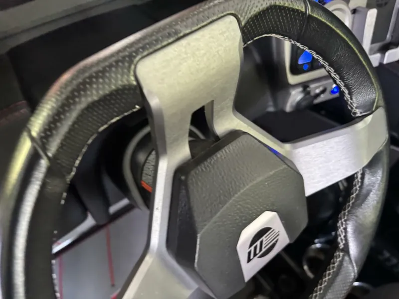 Slide: The Image of Close-up of a steering wheel with a modern design and black accents. - 26
