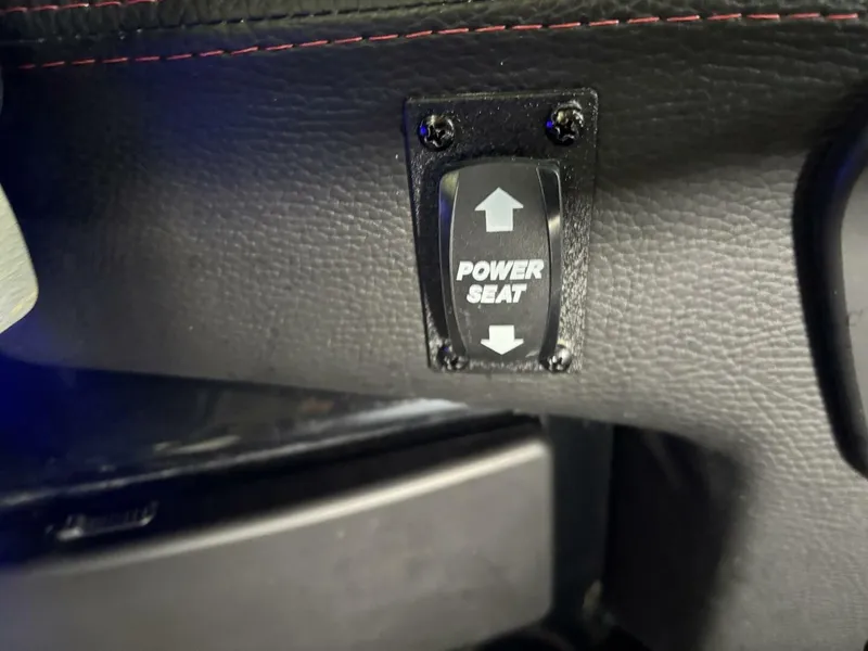 Slide: The Image of Close-up of a power seat switch in a Malibu Wakesetter 23 LSV boat. - 37