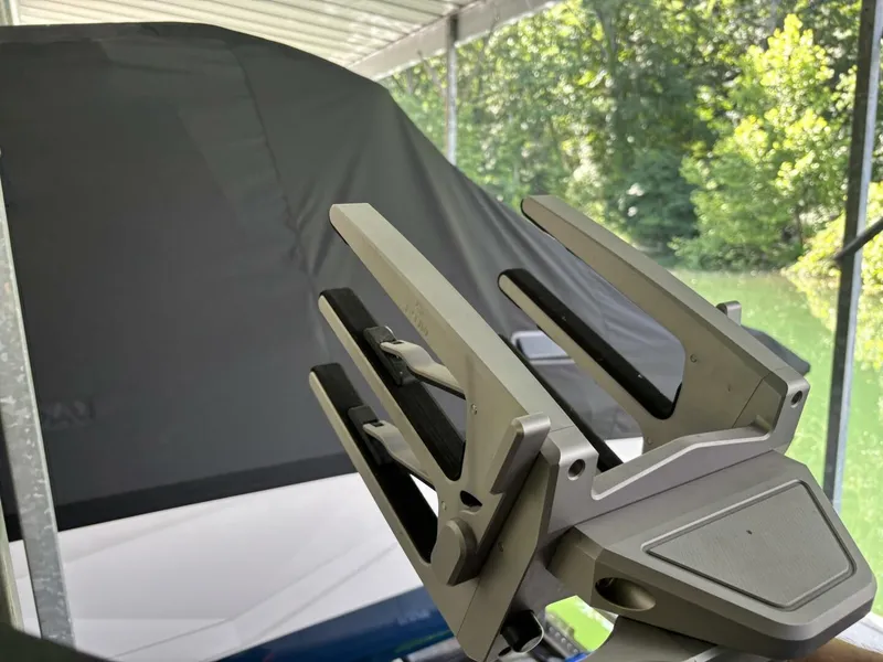Slide: The Image of A 2022 Malibu Wakesetter 23 LSV with a modern wakeboard rack in a covered area. - 38