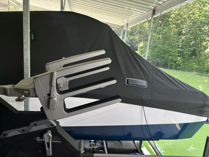 Slide: The Image of A 2022 Malibu Wakesetter 23 LSV is docked under a covered area, partially covered. - 19