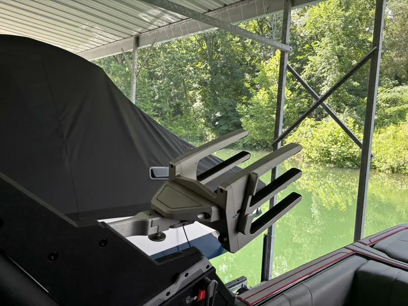 Slide: The Image of A 2022 Malibu Wakesetter 23 LSV is docked under a cover. A wakeboard rack is visible. - 41