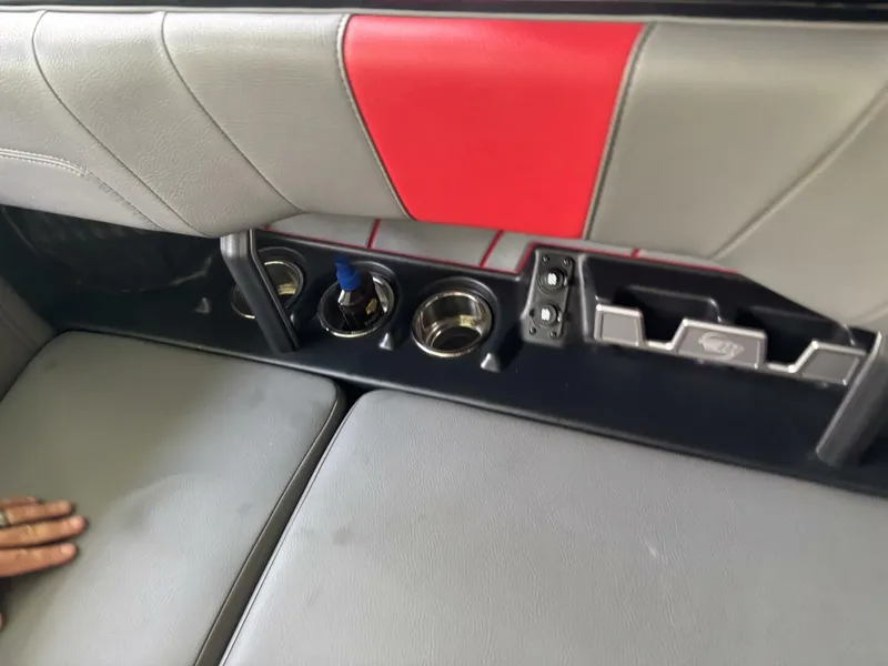 Slide: The Image of Interior of Malibu Wakesetter 23 LSV with gray and red upholstery, cup holders, and storage. - 40