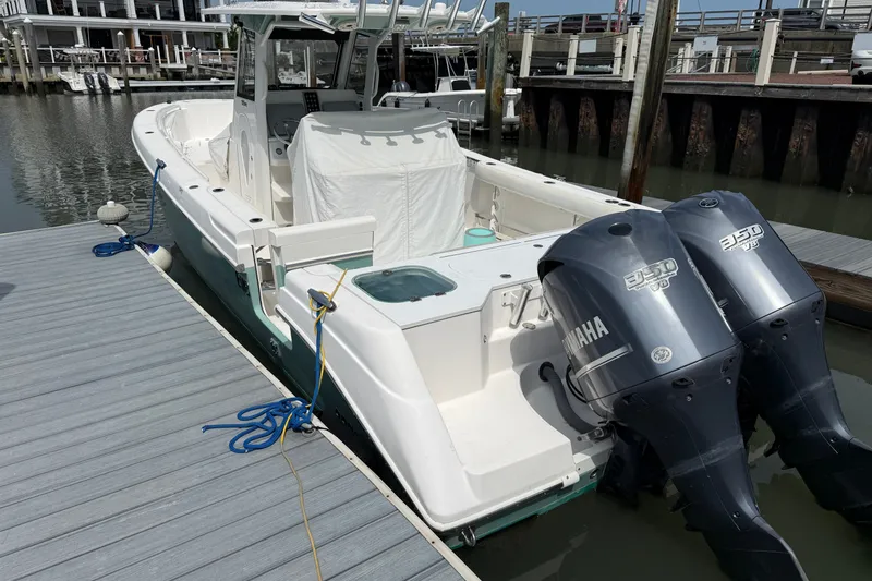 Slide: The Image of 2012 Everglades 325 Center Console boat docked with twin Yamaha engines. - 3