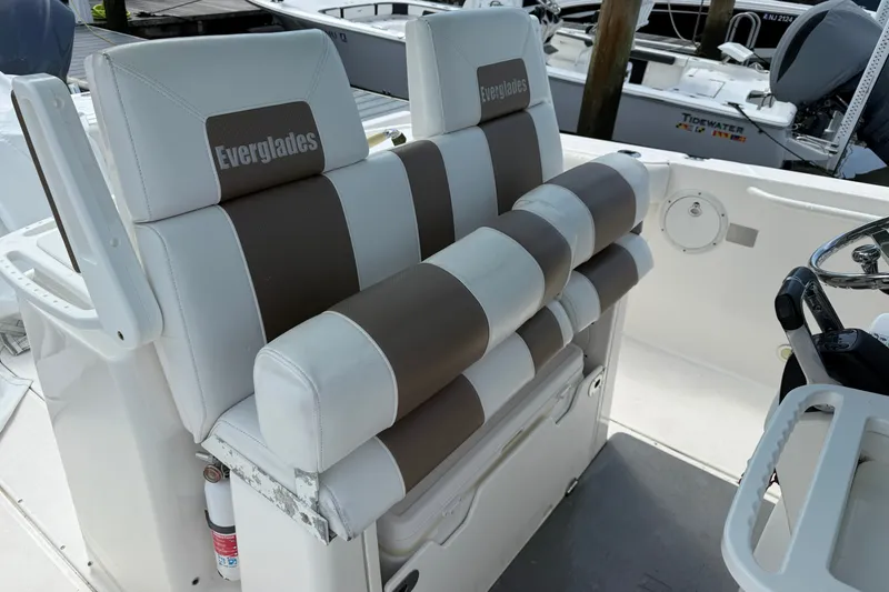 Slide: The Image of 2012 Everglades 325 Center Console boat seating with striped upholstery and branded headrests. - 17