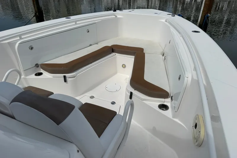 Slide: The Image of 2012 Everglades 325 Center Console boat interior with cushioned seating and storage compartments. - 20